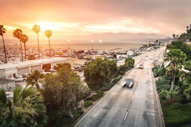 Aerial panoramic view of Ocean Ave freeway in Santa Monica beach at sunset - City streets of Los Angeles and California state surrounds